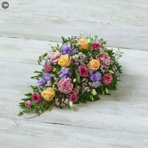 A bouquet of Pastel Oasis Spray flowers on a white surface.