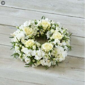 A White Wreath composed of white roses and other white flowers against a wooden background, perfect for SEO."
Product Name: Rose Elegance White Wreath