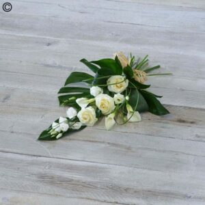 White and Green Tied Sheave of white roses and green foliage arranged, lying on a wooden floor.