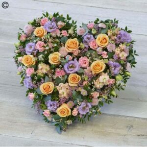 Large Mixed Pastel Heart arrangement on a wooden surface.