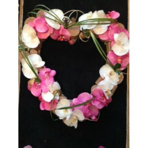Orchid Open Heart wreath, made of pink and white orchids on a black background.