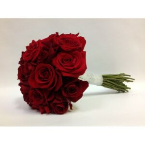 A wedding bouquet of red roses with a white ribbon around the stems.