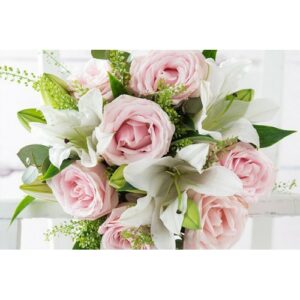 A bouquet of pale pink roses and white lilies with green foliage, perfect for Wedding planning.